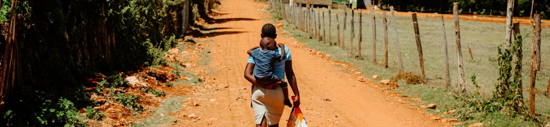 Childcare in Africa, image of a woman carrying a baby on her back