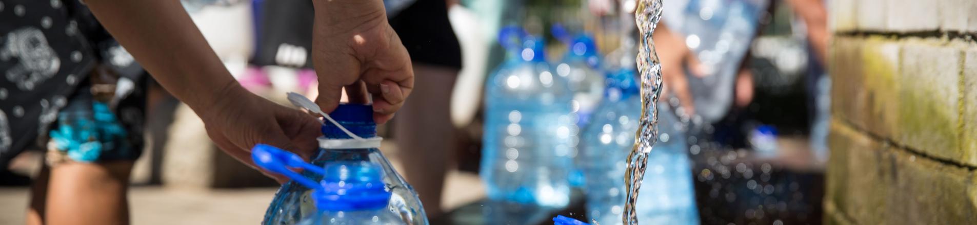 Photo of people filling up water bottles