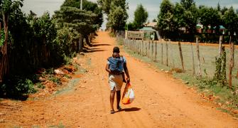 Childcare in Africa, image of a woman carrying a baby on her back