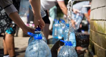 Photo of people filling up water bottles