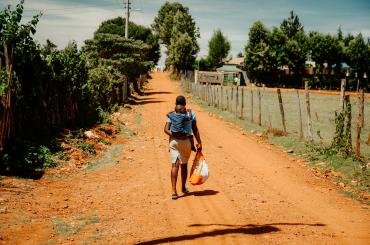 Childcare in Africa, image of a woman carrying a baby on her back