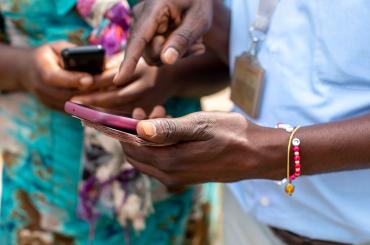 women using mobile money in Africa