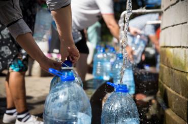 Photo of people filling up water bottles