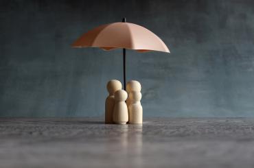 umbrella protecting family, reflecting focus of this article on protecting girls